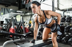 Strong woman working out with dumbbells 400328